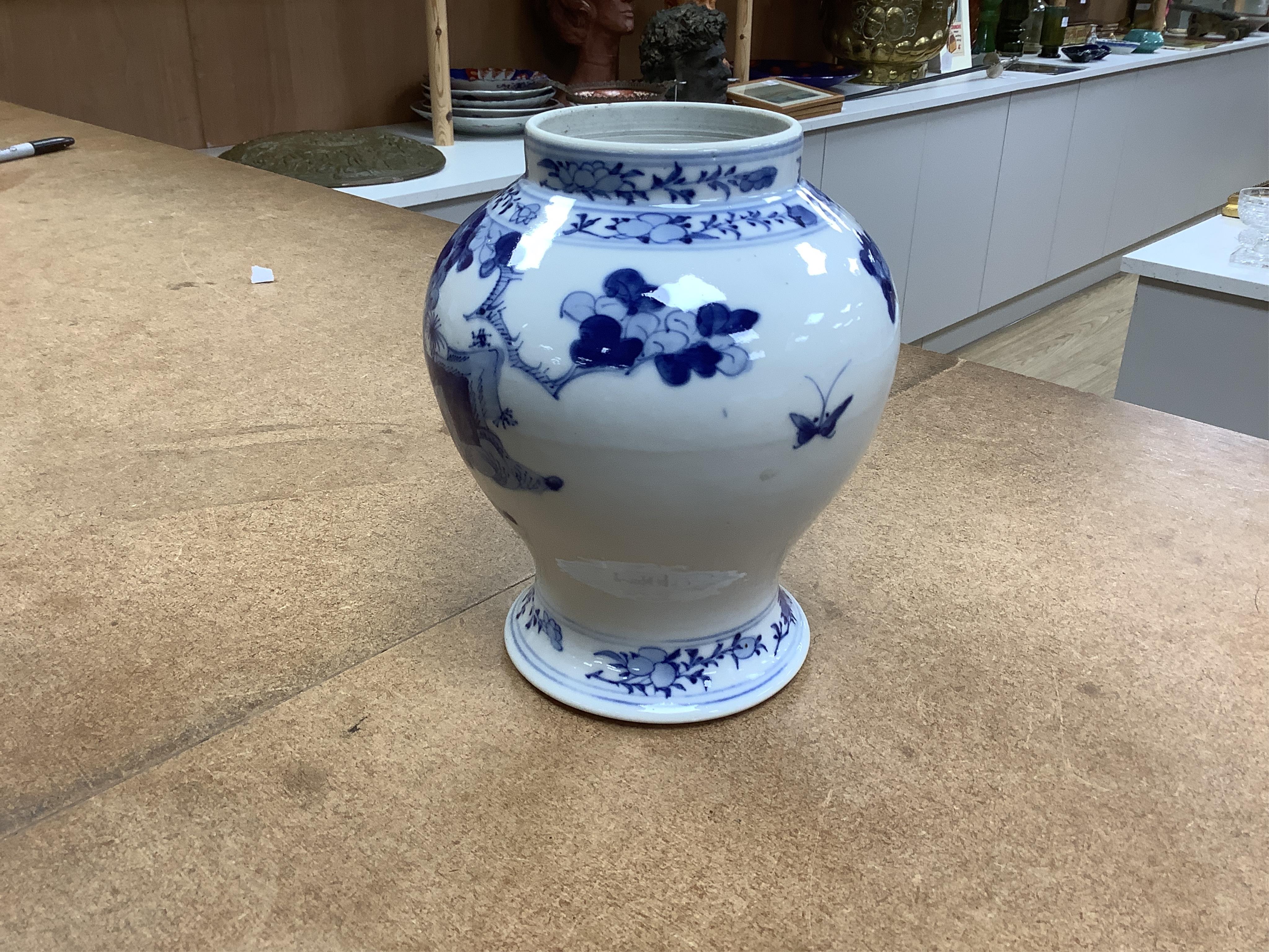 An early 20th century Chinese blue and white porcelain vase and cover decorated with figures in a landscape and a Japanese circular bowl, tallest 23cm. Condition - good